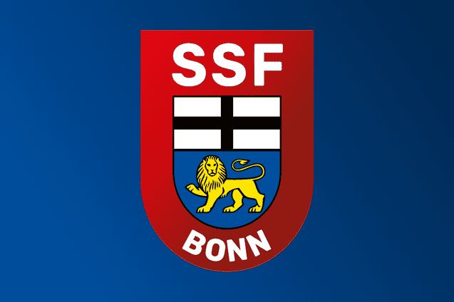 Logo des SSF Bonn mit rotem Schild, wei&szlig;en Balken und einem gelben L&ouml;wen auf blauem Hintergrund.