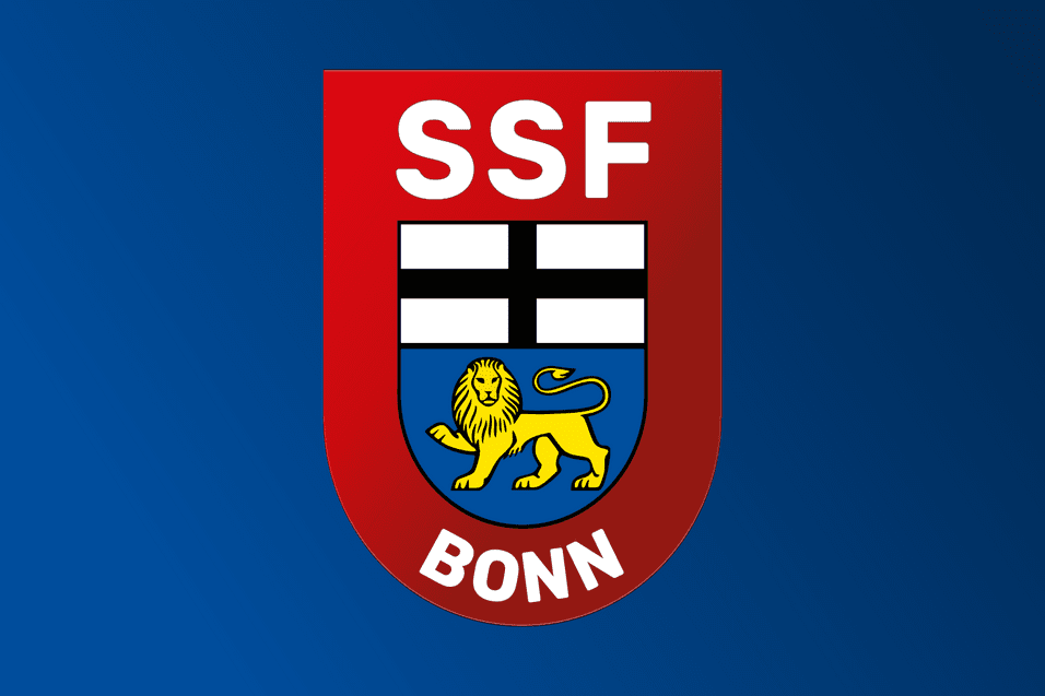 Logo des SSF Bonn mit rotem Schild, wei&szlig;en Balken und einem gelben L&ouml;wen auf blauem Hintergrund.